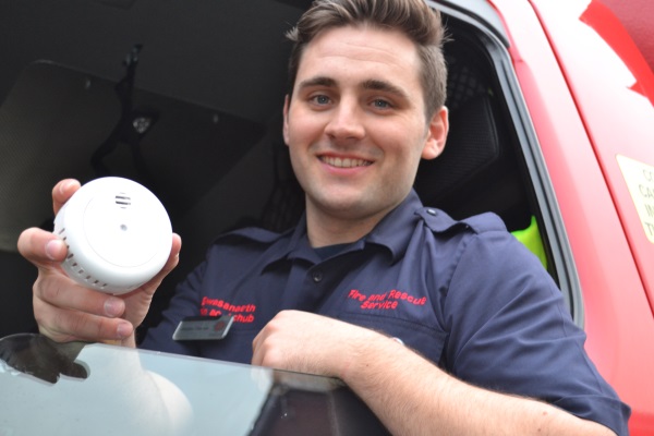 Jordan - Smoke Alarm.JPG Firefighter holding a smoke alarm